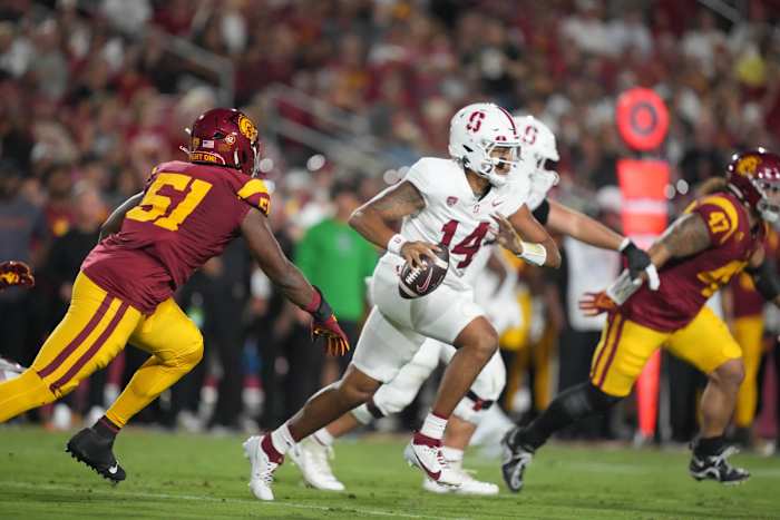 Sep 9, 2023; Los Angeles, California, USA; Stanford Cardinal quarterback Ashton Daniels (14) is pressured by Southern California Trojans defensive end Solomon Byrd (51) n the first half at United Airlines Field at Los Angeles Memorial Coliseum. Mandatory Credit: Kirby Lee-USA TODAY Sports